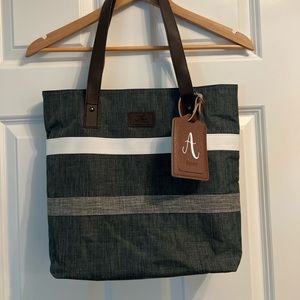 Never used striped zipper tote with removable “A” monogram tag.